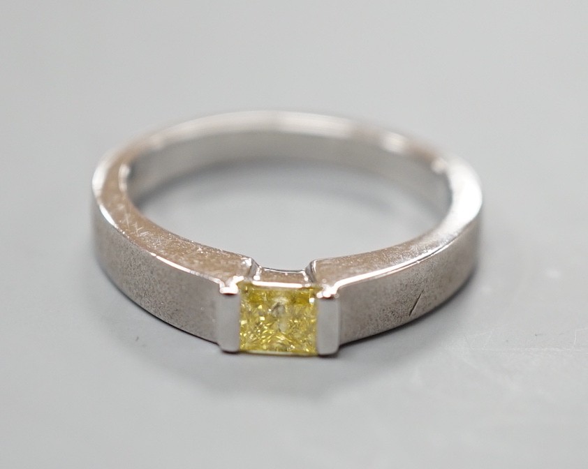A modern sandblasted platinum and solitaire rectangular cut fancy yellow diamond set ring, size M/N, gross weight 7.2 grams